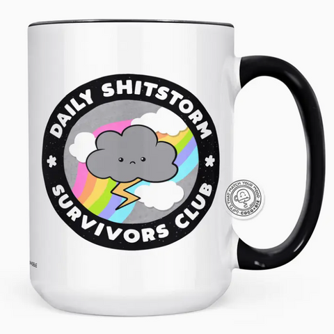 White mug with black handle featuring a cloud and rainbow design on a white background