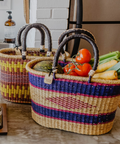 Woven baskets with vegetables on a kitchen counter