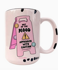 Pink mug with a cartoon design and text on a white background