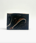 Marbled rectangular object with black, white, and brown colors on a white background