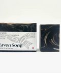 Bar of soap with packaging labeled 'Raven Song' on a white background
