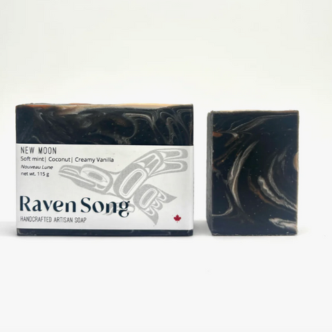 Bar of soap with packaging labeled 'Raven Song' on a white background