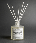 Diffuser bottle labeled 'Sunwashed Breeze' on a dark background