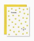 Greeting card with smiley face pattern and 'Thank You' text, yellow envelope.