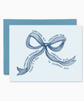 Greeting card with blue bow design and text on a white background