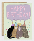 Birthday card with four cats wearing party hats and a speech bubble saying 'Happy Birthday!'.