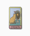 Enamel pin with a cat looking at itself in a mirror with a lion's face, labeled 'Strength'.