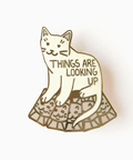 Cat-shaped pin with 'Things are Looking Up' text on a white background