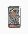 Enamel pin with a cat-like character holding a scepter and flowers, labeled 'The Empress'.