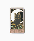 Enamel pin with a cat on a moon and 'The Moon' text on a white background