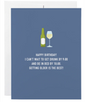 Blue birthday card with a bottle and glass illustration and humorous text.