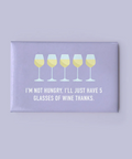 Fridge magnet with wine glass design and humorous text on a purple background