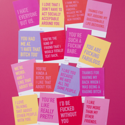 Collection of colorful cards with various text on a pink background