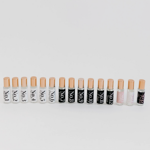 A row of small cosmetic tubes with beige caps and black-and-white labels, arranged horizontally on a light gray background. Small inset thumbnails appear along the left edge.