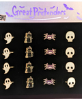 A boxed set of Halloween-themed phosphorescent enamel pins displayed on a black tray under a printed header card. The set includes pumpkins, ghosts, a wizard, spiders, skulls, and purple bats, with text reading 'Great Pretenders' and 'Glow in the Dark.