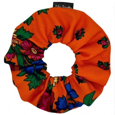 Colorful scrunchie with floral pattern on an orange background