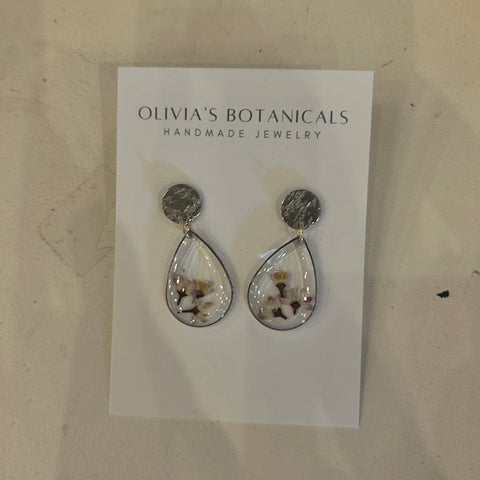 Teardrop-shaped earrings on a card with 'Olivia's Botanicals' branding.