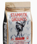 Coffee bag labeled 'Stampede Grounds' with a graphic of a stampeding cow on a white background.