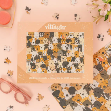 Jigsaw puzzle box with dog pattern and 'villager' branding on a pink background.