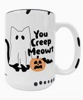 A white ceramic Halloween mug with a black rim, featuring a cartoon ghost cat, a jack-o'-lantern, a bat, and the text 'You Creep Meowt'.
