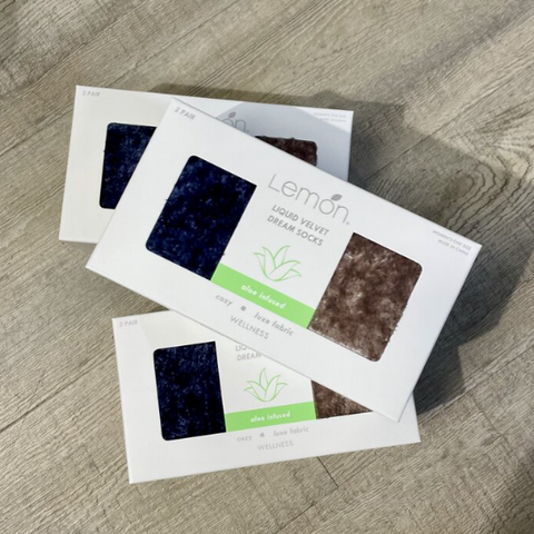 Packaging of Lemon Liquid Velvet Dream Socks on a wooden surface