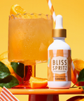 Bliss Spritz bottle with a cocktail on a yellow background