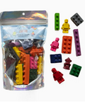 Bag of building blocks and figures with a colorful assortment on a white background