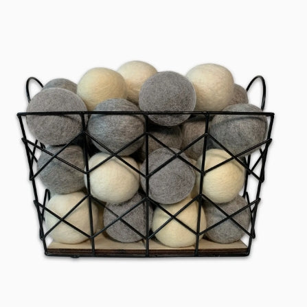Basket filled with gray and beige balls on a white background