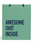 A mint green paper shopping bag with black rope handles and bold navy blue text reading 'AWESOME SHIT INSIDE' on the front, shown against a plain white background.