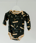 Black baby onesie with fishing pattern on a white hanger against a white background