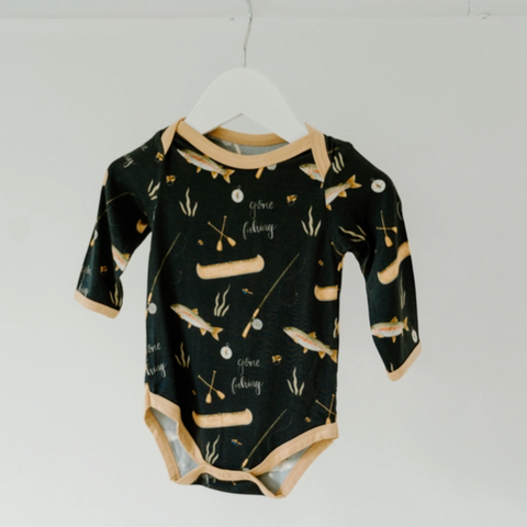 Black baby onesie with fishing pattern on a white hanger against a white background