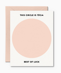 A greeting card with a large pink circle and text 'THIS CIRCLE IS 10cm BEST OF LUCK' on it, accompanied by a pink envelope.