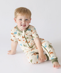 Child wearing a patterned pajama set on a white background