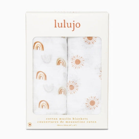 Packaged cotton muslin blankets with rainbow and sun patterns, brand 'lulujo' visible.