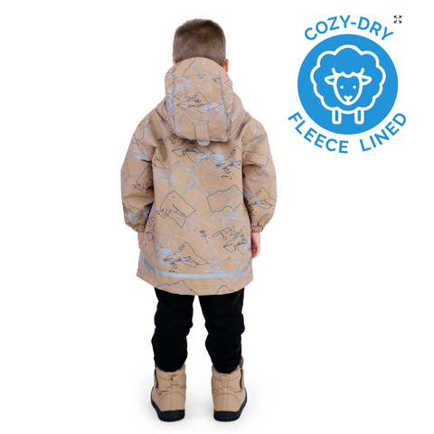 Child wearing a beige coat with animal pattern, standing against a white background, with Cozy-Dry logo on the right.