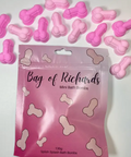 Pink bag of mini bath bombs with packaging on a white background
