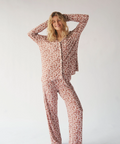 Woman wearing a patterned pajama set on a plain background