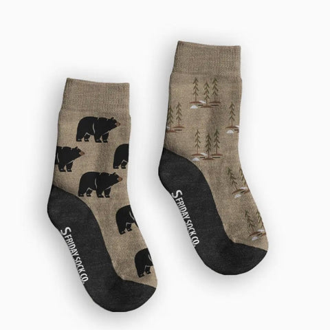 Two pairs of socks with bear and nature patterns on a white background