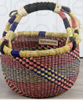 Woven basket with colorful handle on a wooden surface
