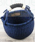 Blue woven basket with handles on a wooden surface