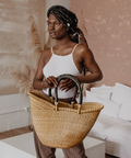 Woman holding a woven basket in a modern living room
