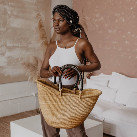 Woman holding a woven basket in a modern living room