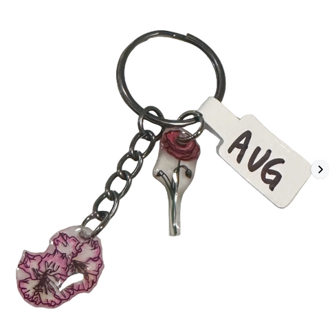 Keychain with floral design and 'AVG' tag on a light gray background