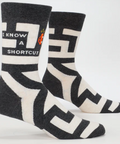 Two socks with geometric patterns and text on a white background