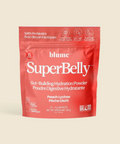 Red package of blume SuperBelly powder on a beige background
