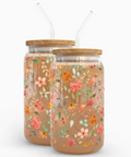 Two floral-patterned jars with wooden lids on a white background