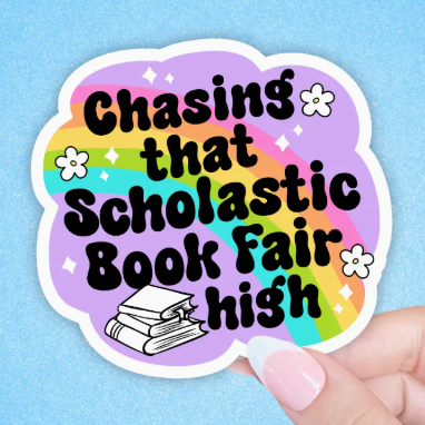 Sticker with 'Chasing that Scholastic Book Fair high' text on a colorful background