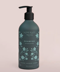 Shampoo bottle with floral design and 'Somerset Moss' branding on a light pink background