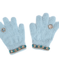 A pair of light blue fuzzy knit gloves with jeweled trim at the cuffs and decorative crystal rings on the backs of the hands, displayed against a solid white background.