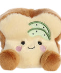 Plush toy resembling a slice of bread with a smiley face and green leaves on a white background